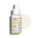 Un flacon compte-gouttes d'Aplb Sérum Ampoule Anti Age Illuminateur Rétinol et Vitamin C 40 ml se tient debout avec une goutte de sérum à côté sur un fond blanc, son étiquette mettant en évidence la formule et 28.1% Retinol Vita CEN. Dakar