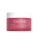 Un pot rose de Caudalie VinoHydra Crème Hydratation Intense 50 ml avec un couvercle blanc et un texte blanc minimaliste est présenté sur un fond blanc. Dakar