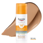 Eucerin Sun Protection Oil Control SPF50+ Gel Crème Teintée Médium 50 ml pour les peaux grasses et acnéiques est représenté avec un fond de crème teintée moyenne. Le flacon porte une étiquette orange et blanche. Dakar