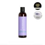 Un flacon de In HairCare Gelée Boucles 250ml avec une étiquette violette est centré, avec deux badges "beauty shortlist award" pour 2025 dans le coin supérieur droit. Dakar