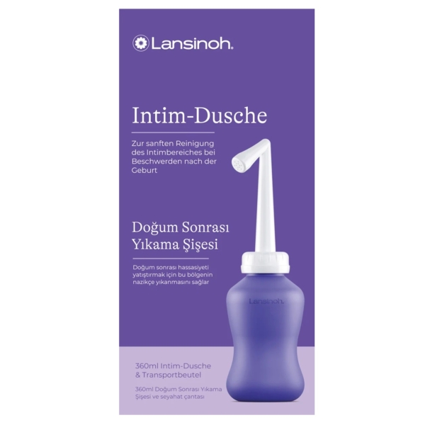 Une boîte violette contient une Douche Intime Périnée Lansinoh blanche et violette (1 pièce). L'emballage, en allemand et en turc, décrit son utilisation pour le nettoyage en douceur de la zone intime après l'accouchement. Dakar