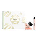 Coffret cadeau de parfum Prada comprenant une boîte décorative blanche et dorée, un flacon triangulaire de parfum rose avec un bouchon noir, et un flacon vaporisateur de voyage. Dakar