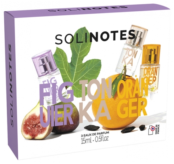 Coffret cadeau de parfum Solinotes présentant trois flacons de 15 ml devant une illustration de figue et de feuille de figuier. Les parfums sont étiquetés Figue, Tonka et Orange, avec un texte coloré en gras se superposant à l'image. Dakar