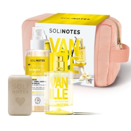 Un coffret Solinotes Vanille comprenant une trousse de toilette rose, un coffret jaune et blanc, un flacon de parfum, un vaporisateur et un pain de savon beige avec le nom de la marque et un cœur en relief. Dakar