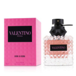 Une boîte rose et noire de Valentino Eau de Parfum Donna Born In Roma 50 ml se trouve à côté d'un flacon en verre transparent et texturé avec un liquide rose et un bouchon noir avec une étiquette rose avec le logo du produit. Dakar
