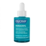 Le flacon en verre bleu de 30 ml de Ducray Keracnyl Sérum Régulateur Anti-Imperfections est doté d'un bouchon compte-gouttes blanc et d'un étiquetage bilingue (français/anglais). Contient un sérum anti-imperfections. Dakar