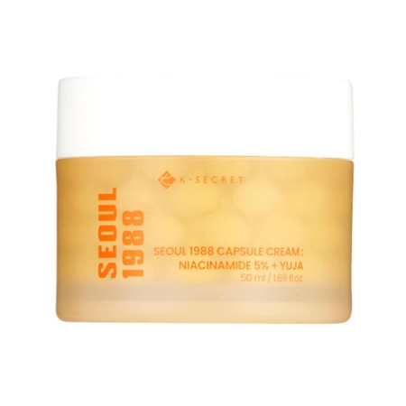 Un pot de K-Secret Seoul 1988 Capsule Cream with Niacinamide 5% and Yuja, 50 ml. Le pot est jaune givré avec un texte orange en gras et un couvercle blanc. Dakar