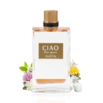 Flacon de parfum Riiffs Ciao Pour Femme by pour femme, transparent, 100ml, avec un bouchon doré, présenté devant un assortiment de petites fleurs et de feuilles vertes sur un fond blanc. Dakar