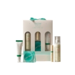 Coffret de soins comprenant cinq produits et un porte-savon en verre turquoise, avec un emballage blanc et vert, présenté devant une boîte blanche portant l'inscription "GLOW YOUR OWN WAY" (ÉCLAIRCISSEZ-VOUS). Dakar