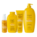 Quatre produits de soins corporels jaunes Byphasse "Glow Sunshine" sont alignés : une huile chatoyante, une lotion pour le corps, un gommage pour le corps et un grand gel douche, chacun étiqueté avec un texte en or et en blanc. Dakar