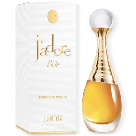 Un flacon de Dior J'adore l'Or Essence de Parfum se trouve à côté de sa boîte blanche et dorée. Le flacon est doré et transparent, avec un bouchon rond et transparent. La boîte est ornée d'un texte doré et de détails élégants. Dakar