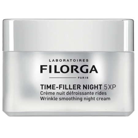 Un pot argenté de Filorga Time-Filler Night 5XP Wrinkle Smoothing Night Cream, avec un texte noir et gris décrivant le produit en anglais et en français sur la face avant. Dakar