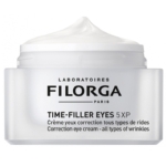 Un pot blanc de crème corrective pour les yeux TIME-FILLER EYES 5XP de Filorga avec un couvercle blanc, comportant un texte noir et gris décrivant la crème comme une crème pour tous les types de rides. Le pot est ouvert, laissant apparaître la crème à l'intérieur. Dakar