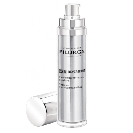 Un flacon argenté de Filorga Fluide Mat Multi Correcteur Suprême de la Peau Ncef Reverse Mat 50 ml avec un distributeur à pompe et un bouchon assorti est placé à côté, le tout sur un fond blanc. Dakar