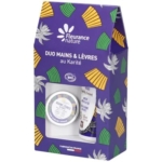 Un coffret cadeau Fleurance Nature violet avec des motifs en éventail jaunes et verts contient un duo de crème pour les mains et de baume à lèvres au karité biologique, étiqueté "Duo Mains & Lèvres au Karité". Dakar