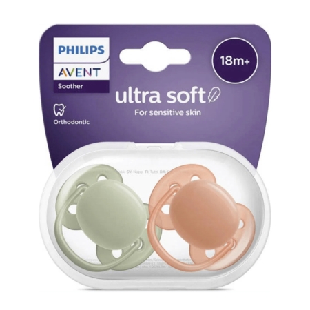Deux sucettes Philips Avent ultra douces pour les bébés de 18 mois et plus, de couleur vert pastel et pêche, présentées dans un étui transparent avec un emballage violet portant la mention "ultra doux pour les peaux sensibles". Dakar