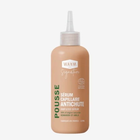 Un flacon beige de WAAM Signature Hair Loss Serum avec un bouchon applicateur pointu, comportant un texte en français et en anglais le décrivant comme un produit anti-chute à base de romarin et d'amla. Dakar