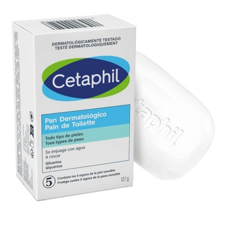 Une boîte et une barre de Cetaphil Pain de Toilette Sans Savon Visage et Corps 127 g, avec un emballage bleu, vert et blanc, étiqueté pour tous les types de peau et en espagnol, indiquant qu'il est doux et se rince à l'eau. Dakar