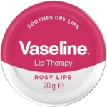 Une boîte ronde de Vaseline Lip Therapy au parfum Rosy Lips, étiquetée "SOOTHES DRY LIPS" (apaise les lèvres sèches). La boîte est rose et blanche et contient 20 grammes de produit. Dakar