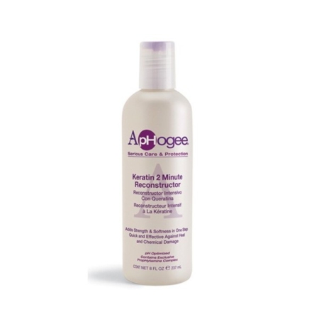 Un flacon blanc d'ApHogee Keratin 2 Minute Reconstructor avec un bouchon violet et un texte violet le décrivant comme un traitement pour renforcer et adoucir les cheveux abîmés par la chaleur et les produits chimiques. Dakar