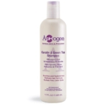 Une bouteille blanche de 355 ml (12 fl oz) du shampooing ApHogee Keratin & Green Tea avec un texte violet, le décrivant comme sans sulfate, sans colorant, et formulé pour apaiser et régénérer les cheveux délicats. Dakar