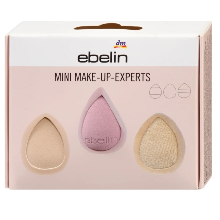 Le coffret "Ebelin Mini Make Up Experts Éponge et Applicateur 1 pièce" comprend trois éponges de maquillage en forme de goutte d'eau - beige clair, rose et beige texturé - sur fond rose pâle. Dakar