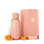 Un flacon de parfum rose avec un accent doré se trouve à côté d'une boîte rose texturée assortie, étiquetée "Sweet Paradise" par French Avenue. Deux abricots secs sont placés près du flacon. Dakar