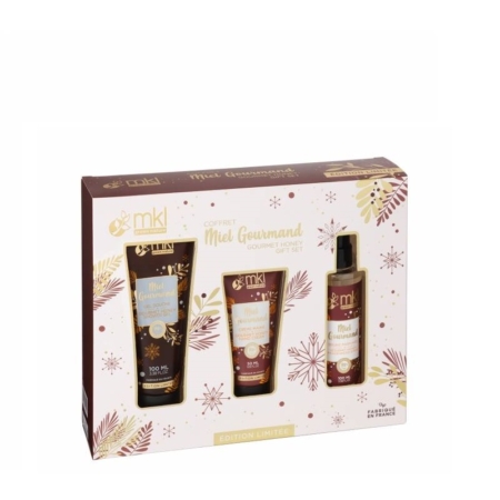Un coffret étiqueté "Coffret Miel Gourmand" de MKL, comprenant trois produits de soin sur le thème du miel : un tube, un flacon pompe et un tube plus petit, avec un emballage festif doré et marron. Dakar