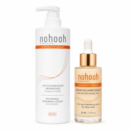 Découvrez le Duo Éclaircissant Expert Visage et Corps Lait + Sérum Anti Taches de Nohooh : une lotion réparatrice blanchissante de 500ml et un sérum anti-taches de 50ml dans un packaging blanc et or pour un visage et un corps éclatants. Dakar