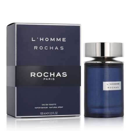 Un flacon bleu foncé de l'eau de toilette L'Homme Rochas Paris se trouve à côté de sa boîte bleue et argentée assortie, toutes deux portant le nom de la marque et du produit. Le flacon est muni d'un bouchon métallique argenté. Dakar