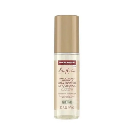 Une bouteille de SheaMoisture Manuka Honey & Mafura Oil Ultra Moisture & Nourish Oil avec un bouchon doré et un corps transparent, contenant 3.3 fl oz (97 ml) de produit. L'étiquette met en évidence les ingrédients issus du commerce équitable et les bienfaits de l'hydratation. Dakar