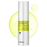 Un flacon blanc de Celimax Retinol Shot Tightening Serum est représenté sur un fond blanc avec des gouttelettes de liquide jaune. L'étiquette met en avant des ingrédients tels que le rétinol, le complexe peptidique et le panthénol pour une peau plus ferme. Dakar