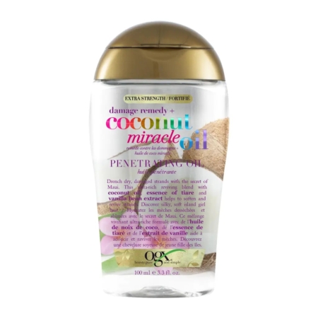 Un flacon transparent de l'huile pénétrante Extra Strength Coconut Miracle Oil d'OGX avec un bouchon doré, une étiquette colorée et des images de noix de coco sur l'emballage ; le flacon contient 100 ml (3.3 fl oz). Dakar