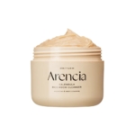 Un pot beige d'Arencia Nettoyant Doux Mochi au Riz et au Calendula Peau Sensible et Sèche 120g, dont le couvercle a été retiré, révèle un nettoyant crémeux beige, réputé pour ses vertus hydratantes et nettoyantes en profondeur pour les peaux sensibles et sèches. Dakar