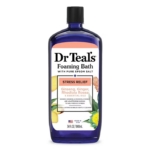 Bain Moussant aux Huiles Essentielles Anti Stress 964 ml, étiqueté "Soulagement du stress", mélange le sel d'Epsom avec des huiles de ginseng, de gingembre et de rhodiola. Le flacon présente des illustrations de gingembre et de feuilles vertes. Dakar