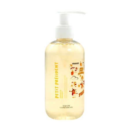 Un flacon pompe transparent étiqueté "Petit Président" avec un texte jaune et des illustrations ludiques orange, contenant un savon liquide jaune clair de Madame La Présidente. Dakar