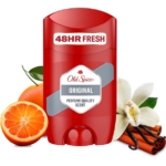 Un bâton rouge de Old Spice Original Déodorant Solide Pour Homme 50ml étiqueté "48HR FRESH" est représenté avec des tranches d'orange, des bâtons de cannelle et une fleur blanche en arrière-plan, faisant allusion à ses ingrédients parfumés. Dakar