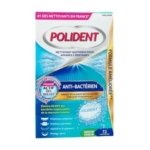 Polident Corega Anti-Bactérien Nettoyant 72 Comprimés boîte avec texte en français, bulles bleues et étiquette "72 comprimés frais aromatisés à la menthe". L'emballage met l'accent sur l'action antibactérienne et la formule améliorée. Dakar