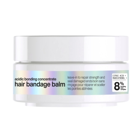 Un pot blanc étiqueté "acidic bonding concentrate hair bandage balm", décrit comme un traitement sans rinçage pour réparer et sceller les pointes abîmées. L'étiquette met en avant un complexe de liaison à 8 % avec de l'acide citrique et du NADESNEMOL. Dakar