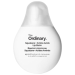 Le baume à lèvres Squalane + Acides Aminés de The Ordinary se présente sous la forme d'un tube blanc en forme d'œuf, avec un texte noir et un bouchon translucide. Le produit contient 15 ml (0.5 fl oz) et fournit un soin hydratant pour les lèvres. Dakar