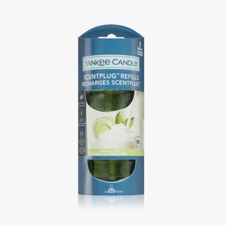 Un paquet de recharges ScentPlug de Yankee Candle dans la senteur Vanilla Lime. L'emballage est bleu avec des images de citron vert et de vanille, et contient deux flacons de recharge visibles à travers une fenêtre transparente. Dakar