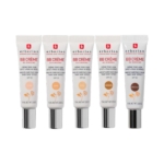 Cinq tubes de BB Crème Erborian sont alignés côte à côte, chacun étiqueté avec une teinte différente : Clair, Doré, Nude, Caramel et Moka. Les tubes sont blancs avec un texte rouge et noir. Dakar