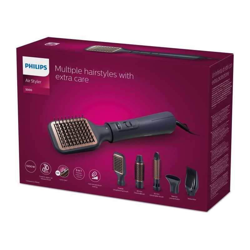 Boîte du Philips Air Styler 5000 avec une photo de l'appareil de coiffure et de ses accessoires sur un fond magenta. Le texte de la boîte indique "De multiples coiffures avec un soin particulier" et montre six têtes de coiffage différentes. Dakar