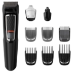 Tondeuse électrique noire avec poignée texturée, présentée avec plusieurs peignes et têtes détachables pour la coupe des cheveux, de la barbe et du nez, disposés proprement sur un fond blanc. Dakar