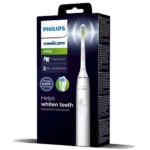 La brosse à dents électrique Philips Sonicare 4100 blanche est présentée dans son emballage, qui met en avant des caractéristiques telles qu'un capteur de pression, deux modes de brossage et une technologie sonique avancée pour des dents plus blanches. Dakar