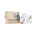 Une trousse de toilette beige à fermeture éclair, ornée d'un motif floral et d'oiseaux bleus, exposée à côté de quatre produits de soin de la peau de marque Rituals, de couleur blanche, présentés dans divers flacons et tubes. Dakar