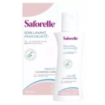 Un flacon blanc de Saforelle Soin Lavant Fraîcheur 2 en 1 Cleansing Care est présenté à côté de sa boîte assortie. Tous deux affichent un marquage bleu et rose, avec des détails sur le produit et un logo en forme de feuille, et contiennent 100 ml. Dakar