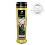 Un flacon de 240 ml de Shunga Huile de Massage Organique Sans Parfum avec une étiquette or et noire comportant une illustration artistique de couple. Les ingrédients certifiés biologiques et la formule sans parfum sont les points forts de cette huile. Dakar