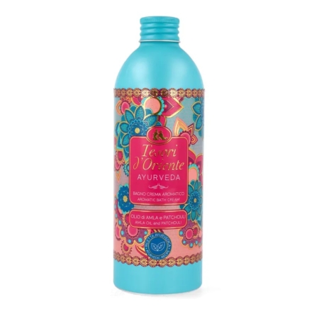 Un flacon rose et sarcelle de la crème de bain aromatique Tesori d'Oriente Ayurveda, orné de motifs floraux et portant l'inscription "Olio di Amla e Patchouli" sur le devant. Dakar