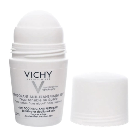 Un flacon de déodorant roll-on blanc étiqueté "Vichy Déodorant Anti-Transpirant 48H" pour les peaux sensibles ou épilées, avec son bouchon blanc placé à côté. L'emballage comporte des informations en français et en anglais. Dakar